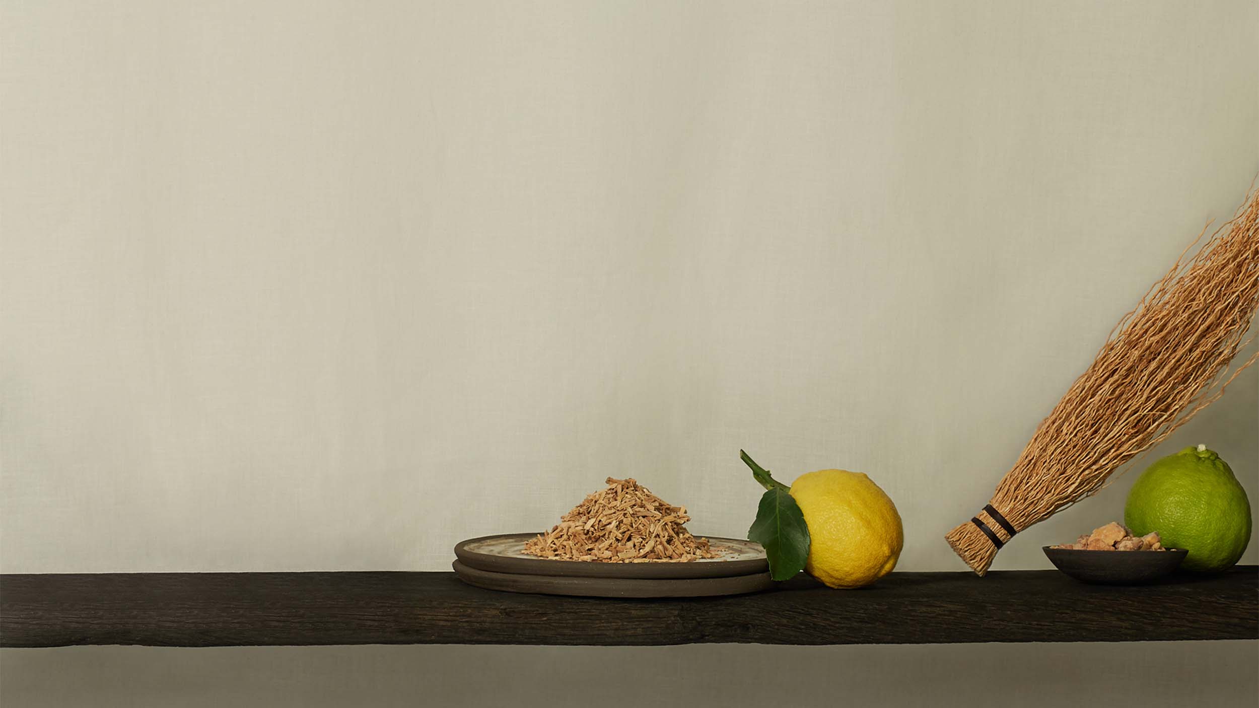 Aromatherapy ingredients such as sandalwood, lemon, vetiver, benzoin and bergamot displayed on a shelf