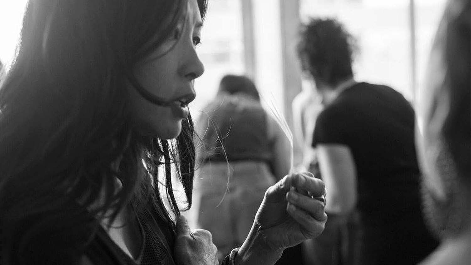 Perfumer and Nose Yosh Han at a perfume industry event smelling perfumes on scent paper